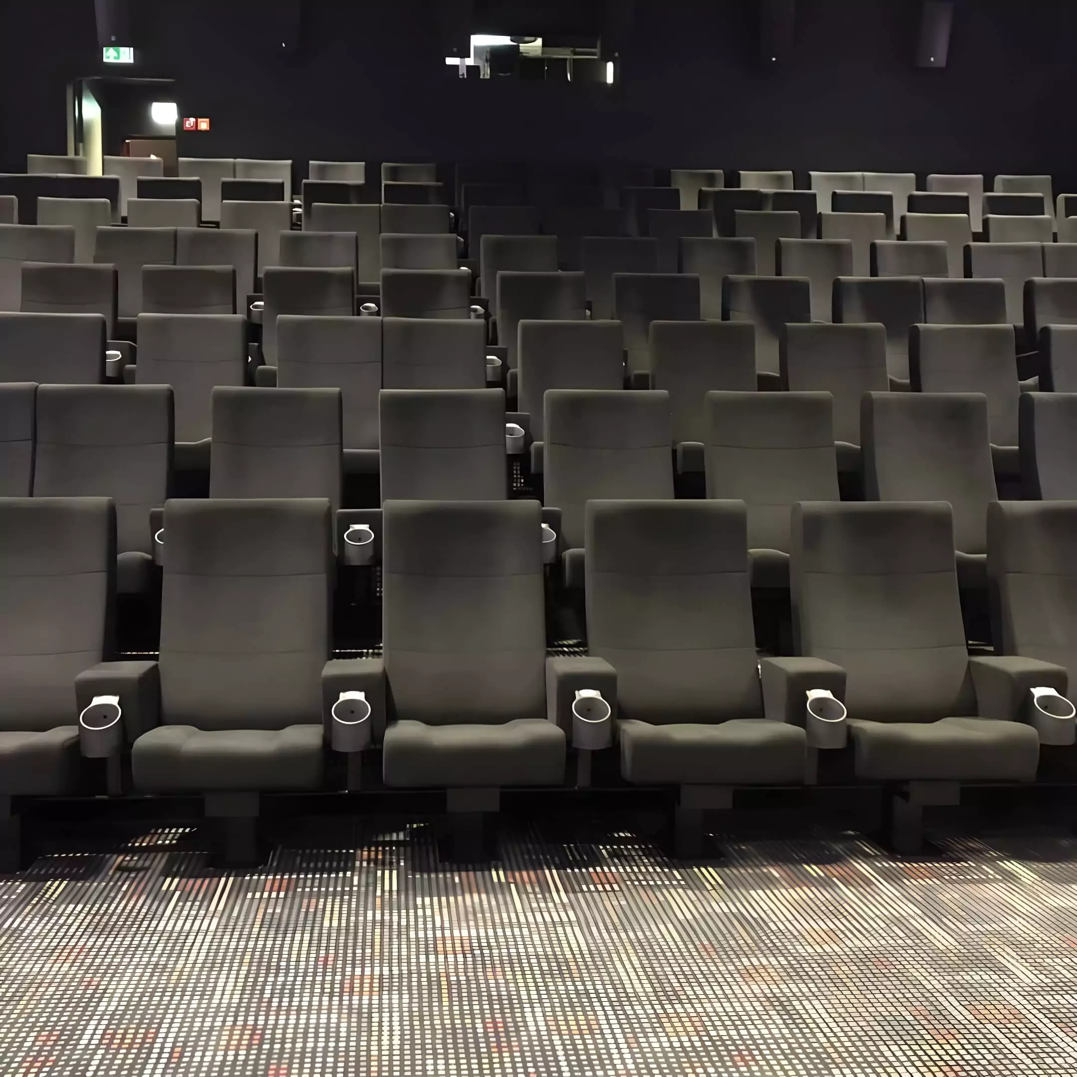 Custom cinema seats with integrated cup holders Image